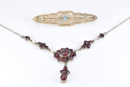 A silver necklace set with bohemian cut garnets, length 45cm, and a yellow metal pierced brooch, 1 x