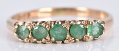 A 9ct gold ring set with emeralds, 1.8g, size M