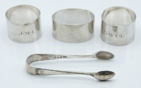 Three hallmarked silver napkin rings including a pair, one Edinburgh 1943 and a pair of hallmarked