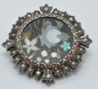 Victorian silver brooch set with a pietra dura plaque surrounded by seed pearls, diameter 2.5cm