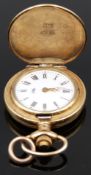 Unnamed 9ct gold pocket watch with gold hands, black Roman numerals, white dial and quartz movement,