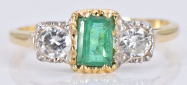 An 18ct gold ring set with an emerald cut emerald and two diamonds, each approximately 0.2ct, 3.