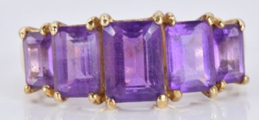 A 9ct gold ring set with emerald cut amethysts, 2.4g, size M