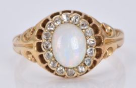 A late Victorian ring set with an oval opal cabochon surrounded by rose cut diamonds, 5.5g, size O/