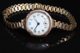 9ct gold ladies wristwatch with subsidiary seconds dial, blued hands, black Arabic numerals, gilt