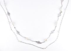 Two early 20thC 9ct white gold necklaces set with seed pearls. length 39cm