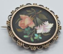 A c1900 Victorian silver brooch set with a pietra dura plaque, diameter 2.5cm