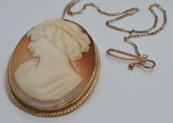 A 9ct gold brooch set with a cameo with an unusual guard chain, 3 x 4cm