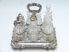 Silver plated seven bottle cruet with ornate cast decoration, width 25cm, depth 19cm, height 27cm