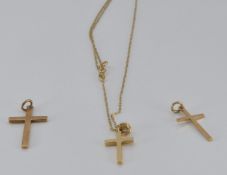 Three 9ct gold crosses and a 9ct gold chain, 3.1g