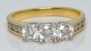 An 18ct gold ring set with three diamonds of approximately 0.3ct, 0.25ct and 0.25ct and further
