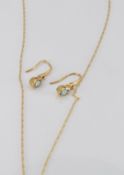 A 9ct gold necklace set with an blue topaz and a diamond and a similar pair of 9ct gold earrings,