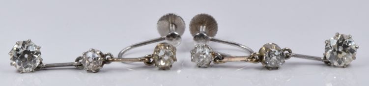 A pair of Art Deco 9ct white gold earrings set with three old cut diamonds, the largest