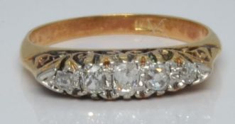 An 18ct gold ring set with five old cut diamonds, 3.0g, size L