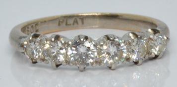 An 18ct white gold ring set with six diamonds in a platinum setting, the largest diamond