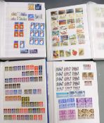 Four stockbooks George VI to QEII. Mint including blocks and used, Machins etc