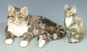 A large Winstanley cat and a seated example, both signed and numbered 1 and 2, H19.5 x L37cm and