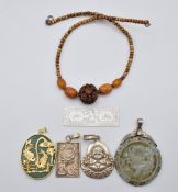 A silver pendant set with a dragon, Buddha pendant, quartz pendant, mother of pearl counter and a