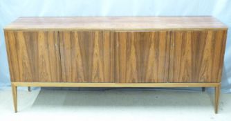 Retro / mid century modern rosewood sideboard with four doors raised on four square tapering legs in