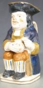 A 19thC Prattware Toby jug with foaming quart