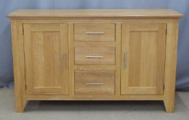 Contemporary light oak sideboard with three drawers flanked by cupboards, W150 x D48 x H85cm