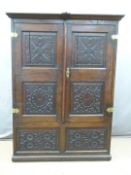 An 18th/19thC peg jointed carved oak cupboard/wardrobe, W123 x D50 x H182cm  DAVE SCARRETT-SMITH