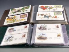 Eight thematic albums of first day covers relating to Butterflies, Cats, Transportation, Flowers,