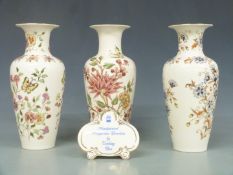 Three Zsolnay Pecs vases and an advertising plaque, tallest 27cm