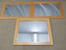 Three light oak mirrors, two with bevelled glass, largest 70 x 88cm