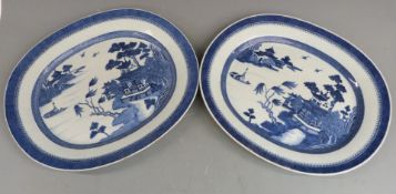 A pair of 19thC Chinese oval chargers decorated with the willow pattern, 38 x 45cm
