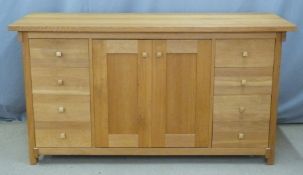 Contemporary Arts and Crafts style light oak sideboard with eight drawers flanking cupboards, W160 x