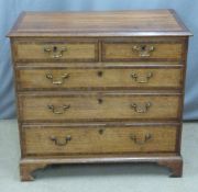 George III crossbanded oak bachelor's chest of two over three graduated drawers raised on bracket