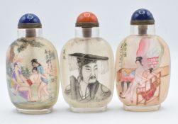 Three Chinese glass reverse painted scent bottles with quartz and lapis lazuli stoppers, 9cm