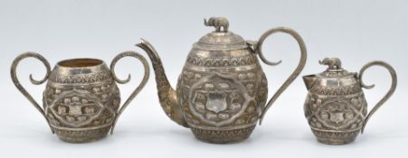 Indian or Burmese white metal bachelor's tea set with elephant finials and embossed decoration of