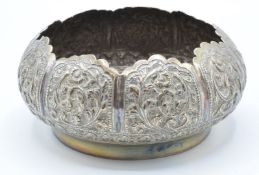 Indian or Burmese white metal bowl with embossed foliate decoration, marked to base T85, diameter