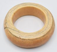 An 18th/19thC African ivory tribal bangle with dot decoration, external diameter 10cm, internal 6cm