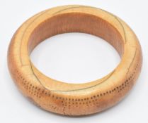 An 18th/19thC African ivory tribal bangle with geometric dot decoration, external diameter 9cm,