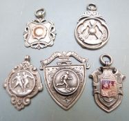 Four silver football award watch fobs together with a miniature shield, Aston Junior League,