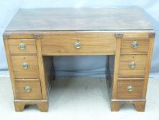 Late 19th/20thC mahogany twin pedestal desk raised on bracket feet and with a protective glass