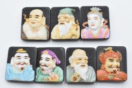 Seven Toshikane Japanese porcelain buttons each depicting a different god of fortune