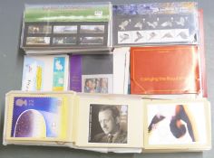 A box of GB presentation packs, PHQ cards, coin/stamp covers and Royal Mail postcards