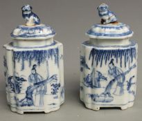 A pair of 19thC Chinese blue and white covered tea caddies with figural decoration and Foo Dog
