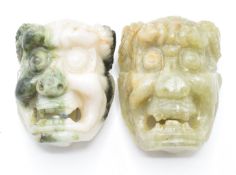 A pair of Chinese Bowenite buckles in the form of masks, 5cm