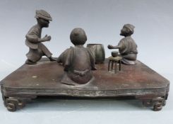 Chinese bronze tableau of three figures, probably playing dice, an unrelated tortoise and vessel,