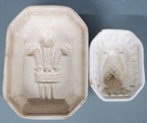 An unusually small pineapple jelly mould, impressed no 8, and a larger fleur de lys example raised