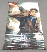 Three large cinema film posters comprising Harry Potter 7 part 2, James Bond Quantam of Solace and