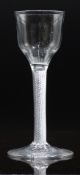An 18thC drinking glass with air twist stem and ogee shaped bowl, 14.8cm tall.