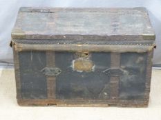 A 19thC fabric covered and lined metal bound trunk with steel drop handles and backplates, the