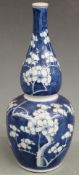 A 19thC Chinese double gourd vase decorated with prunus blossom, four character mark to base, H31cm