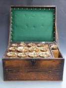 A graduated set of fourteen bronze handbells, each fitted with leather handles. The bells stamped 'J